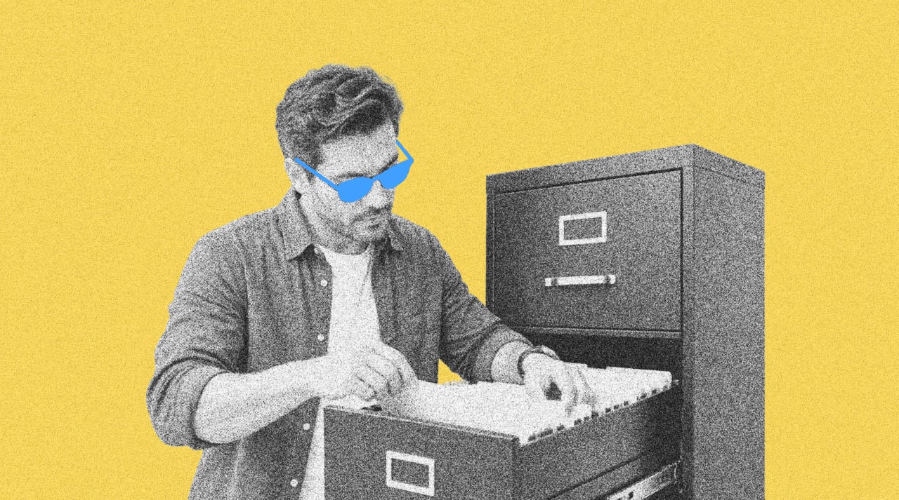 HR manager looking at payroll records in a filing cabinet