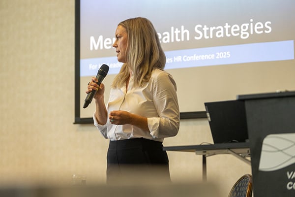 Speaker on stage during a presentation at the Western Cities HR Conference 2025.