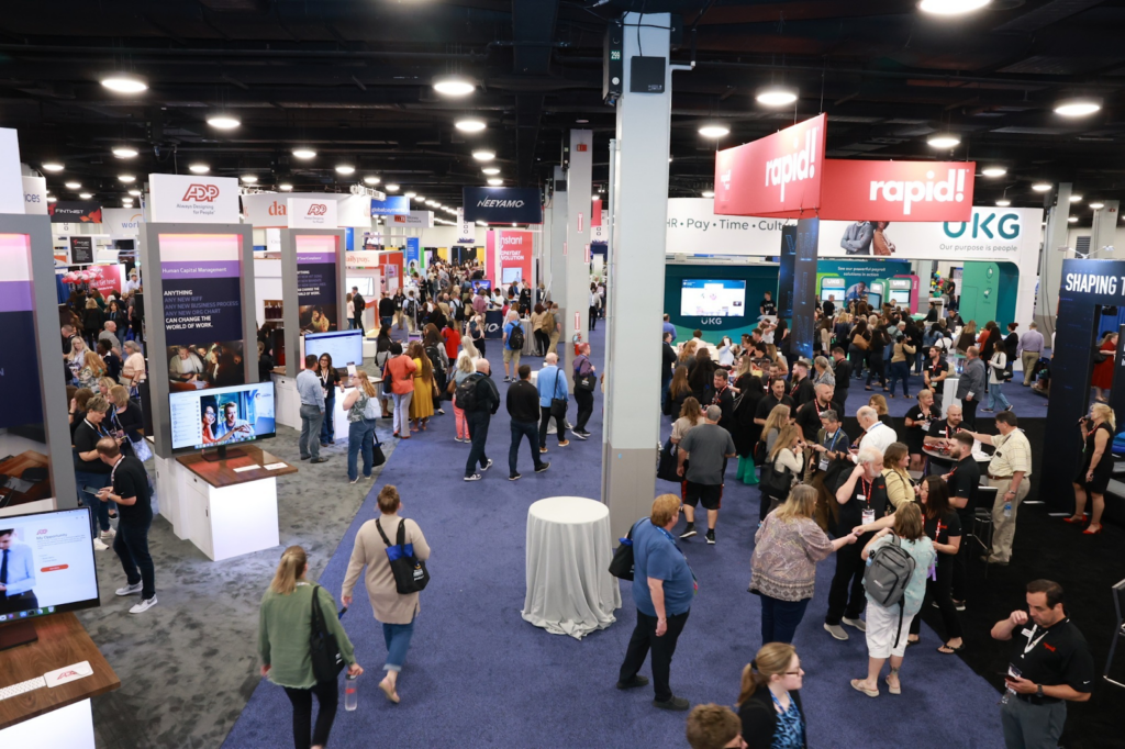Attendees networking and exploring the trade show floor of the Payroll Congress Convention &amp; Expo
