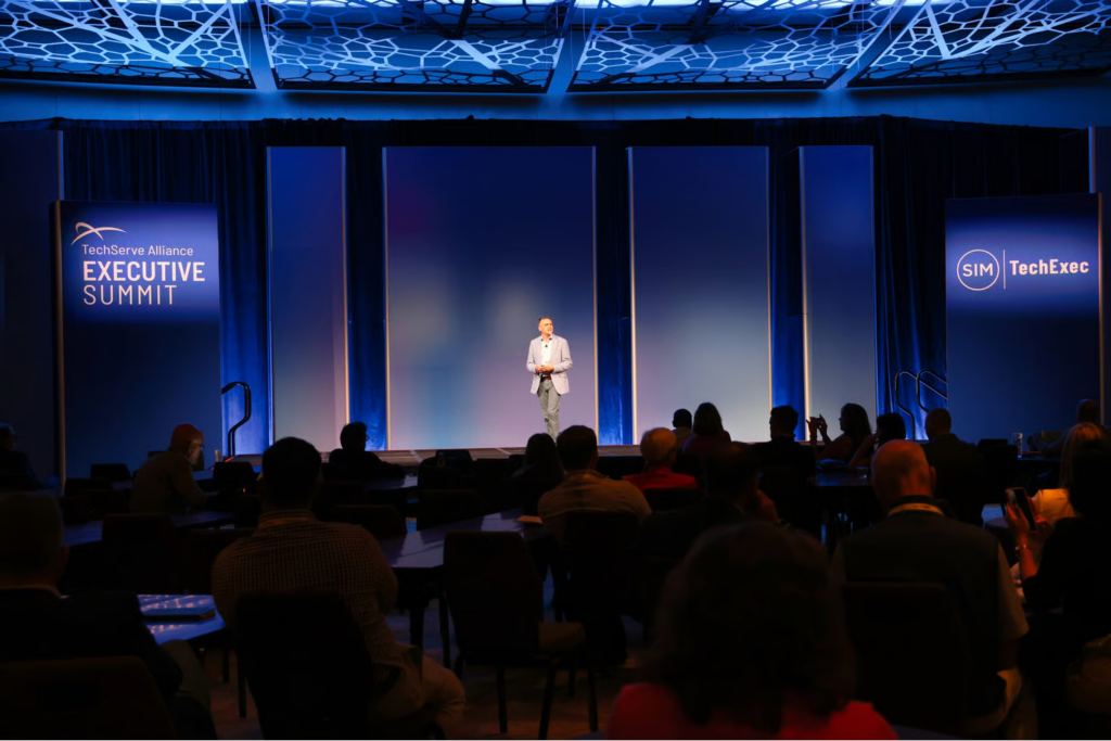 Speaker on stage at TechServe Alliance Executive Summit