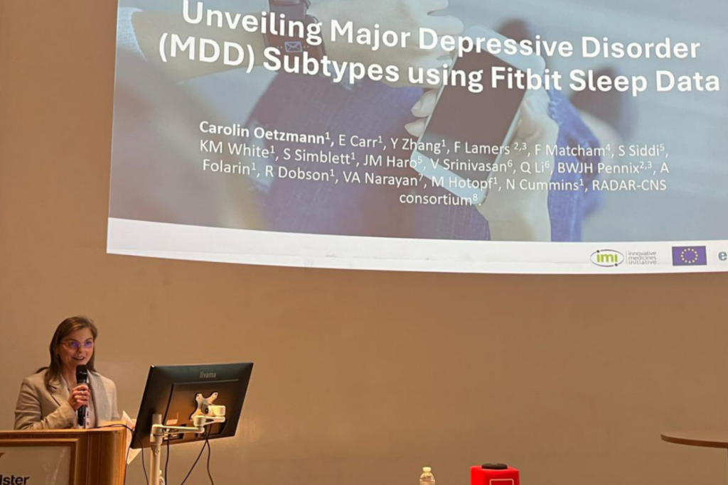 Speaker presenting digital mental health research at the Digital Mental Health and Wellbeing Conference in Glasgow