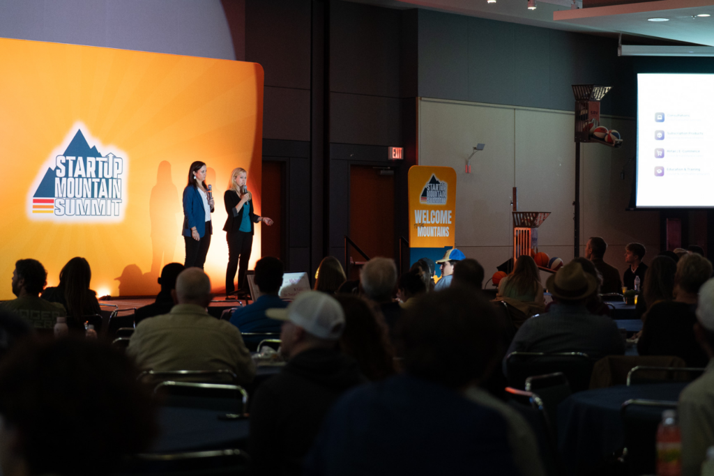 Speakers presenting on stage at Startup Mountain Summit