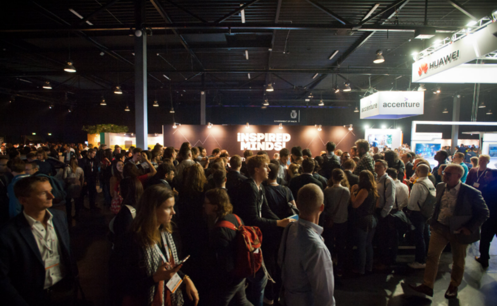World Summit AI 2025 packed exhibition space with attendees and sponsor booths at the venue