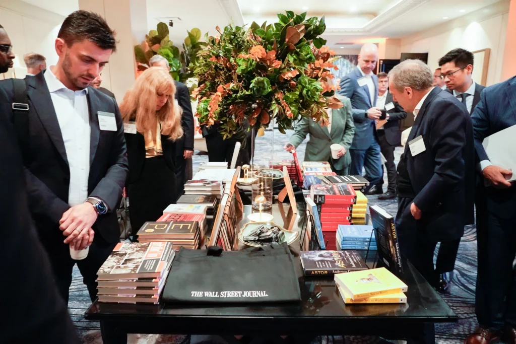 Attendees browsing books and networking at the CFO & COO Council Summit