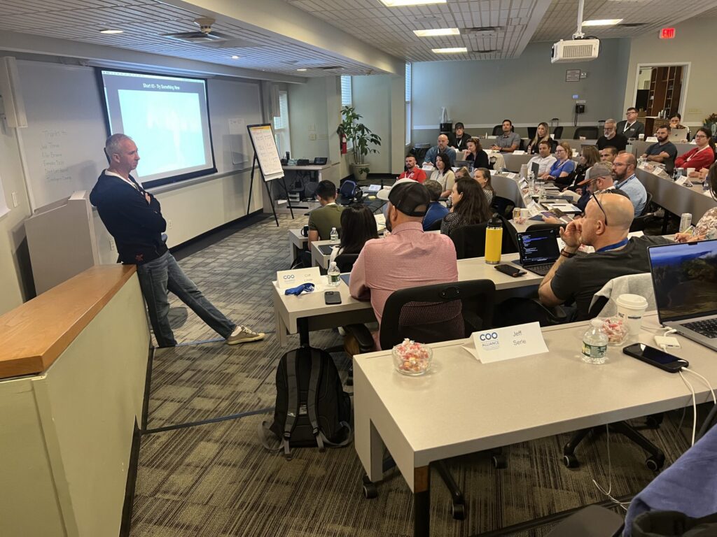 A speaker leading a workshop session with attendees at COO Connect