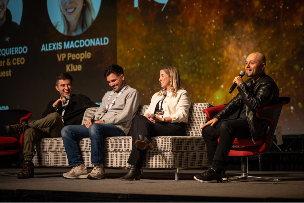 Panelists seated on stage of SaaS North conference