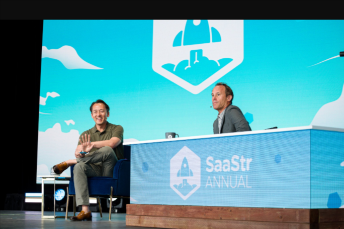 Speakers discussing on stage at the SaaStr Annual conference for founders