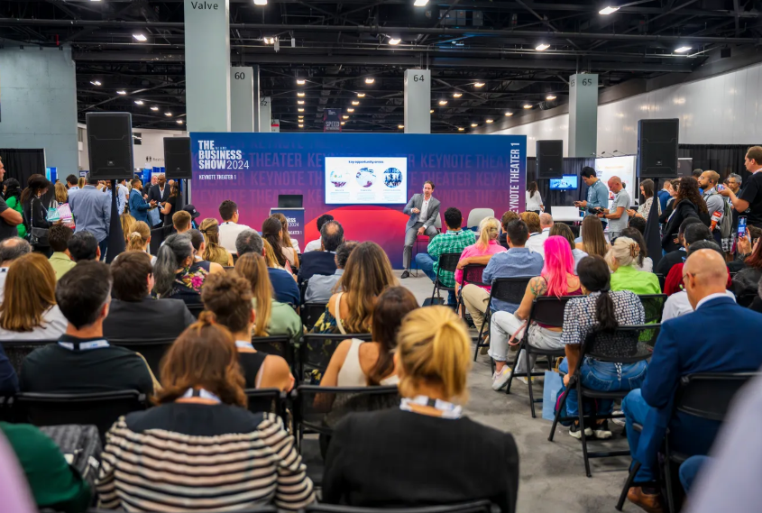 Attendees at The Business Show conference watching a keynote presentation