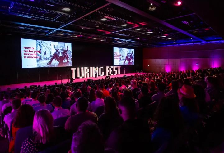 Audience engaged in a presentation at The Turing Fest