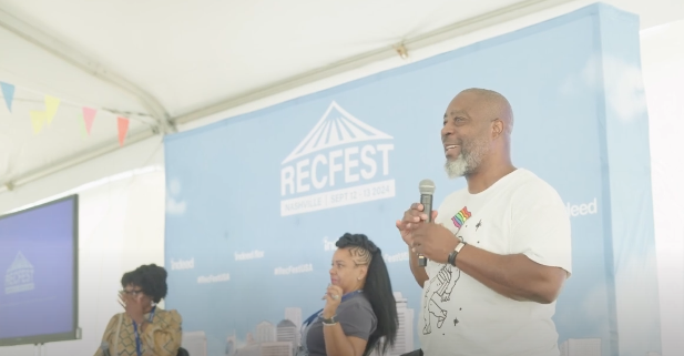 A speaker addresses the audience at RecFest USA