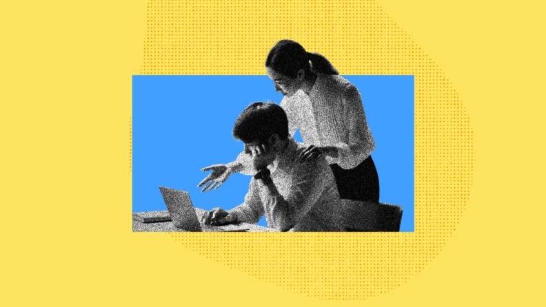 A woman helps guide an employee as he works on his computer.