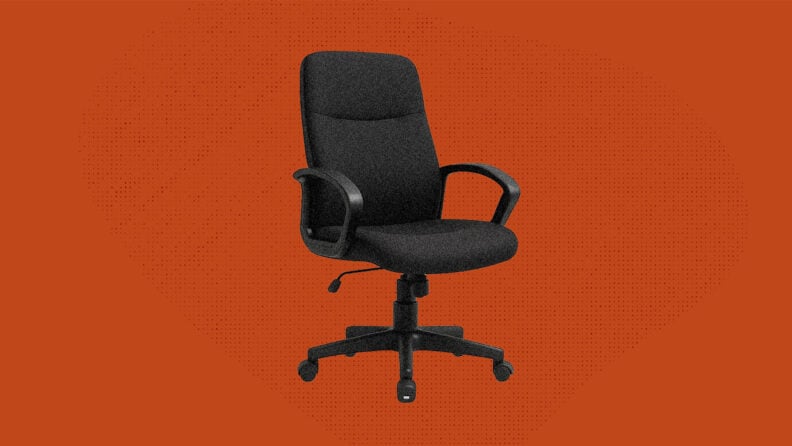 An empty chair in front of a blank red background