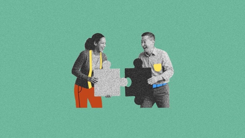 Two people put puzzle pieces together with smiles on their face to represent engaged employees working together